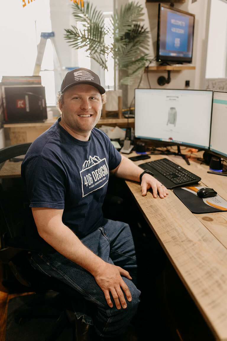 Jayme Robins, owner of 406 Design, at his desk in the Lewistown shop